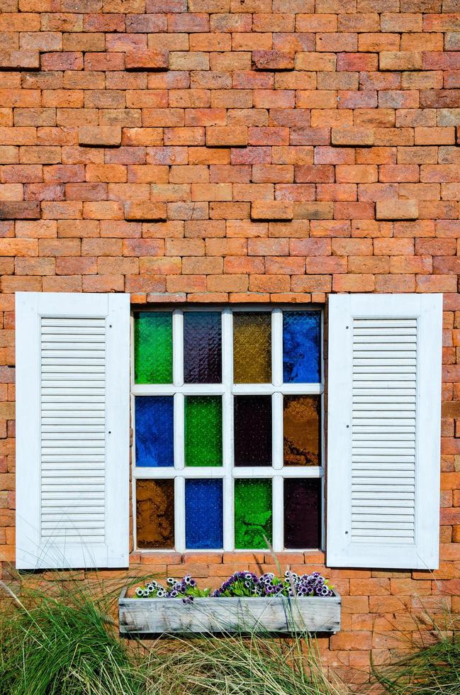 Window on orange brick wall photo