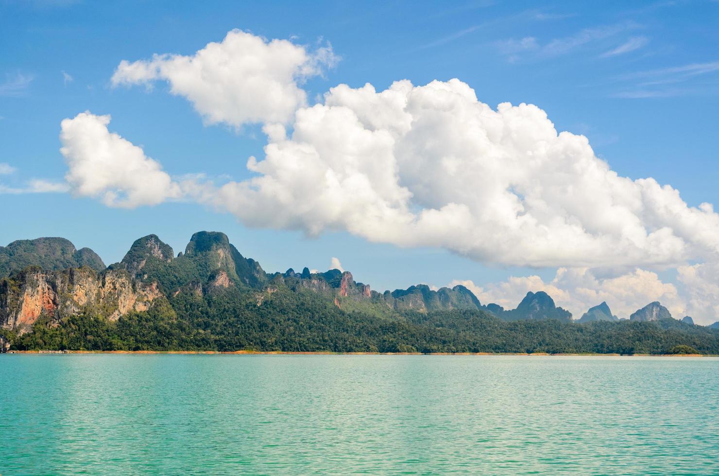 High mountain range above the green lake photo