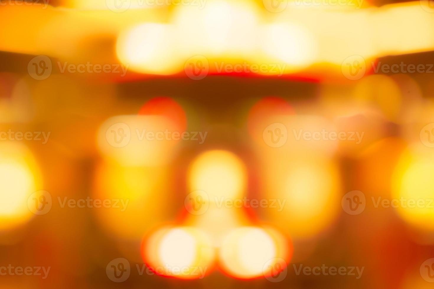 Blur gold, orange, and red color bokeh background. Blur abstract background for Christmas day. Light with a beautiful pattern of round bokeh. Orange festive light in the night. Flare lights at night. photo