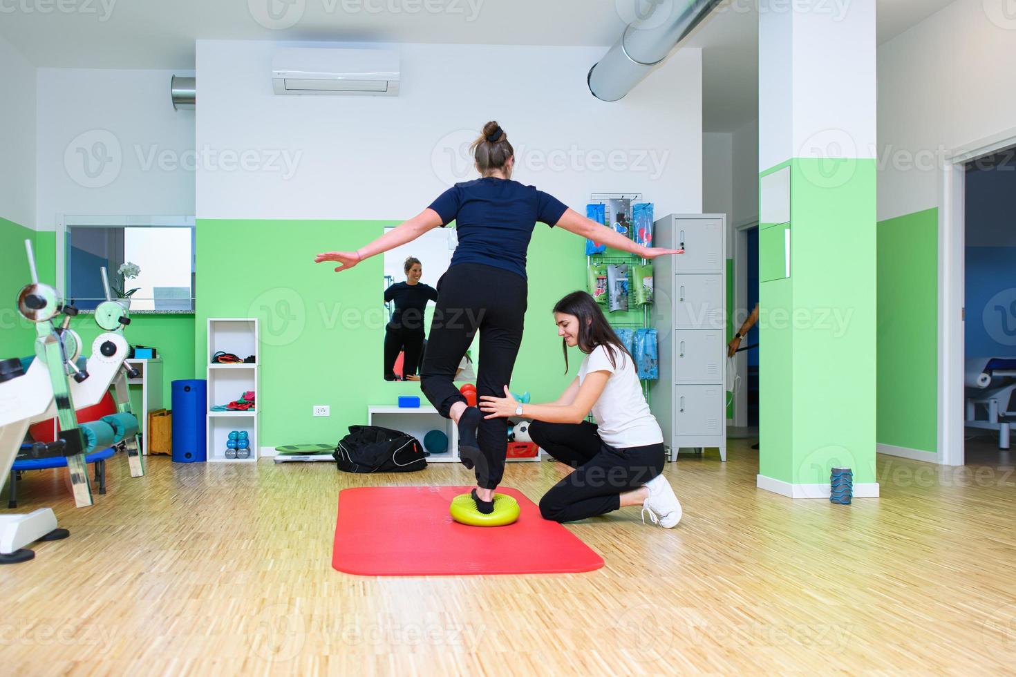 A physiotherapist has a patient perform exercises for ankle proprioception photo