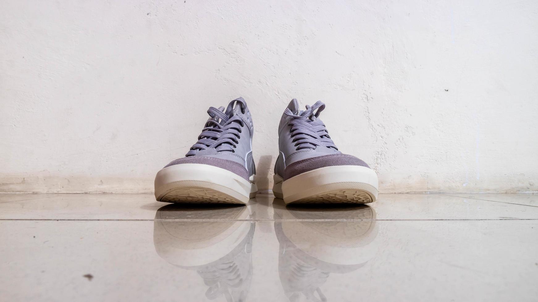 the gray sneakers on the floor photo