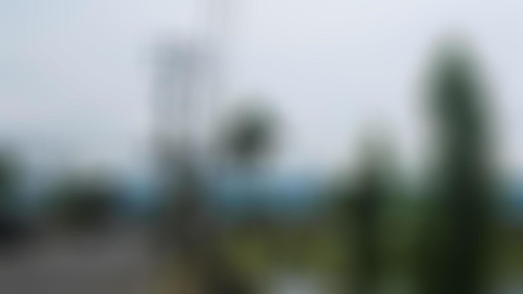 defocused electric pole by the roadside with overcast clouds photo