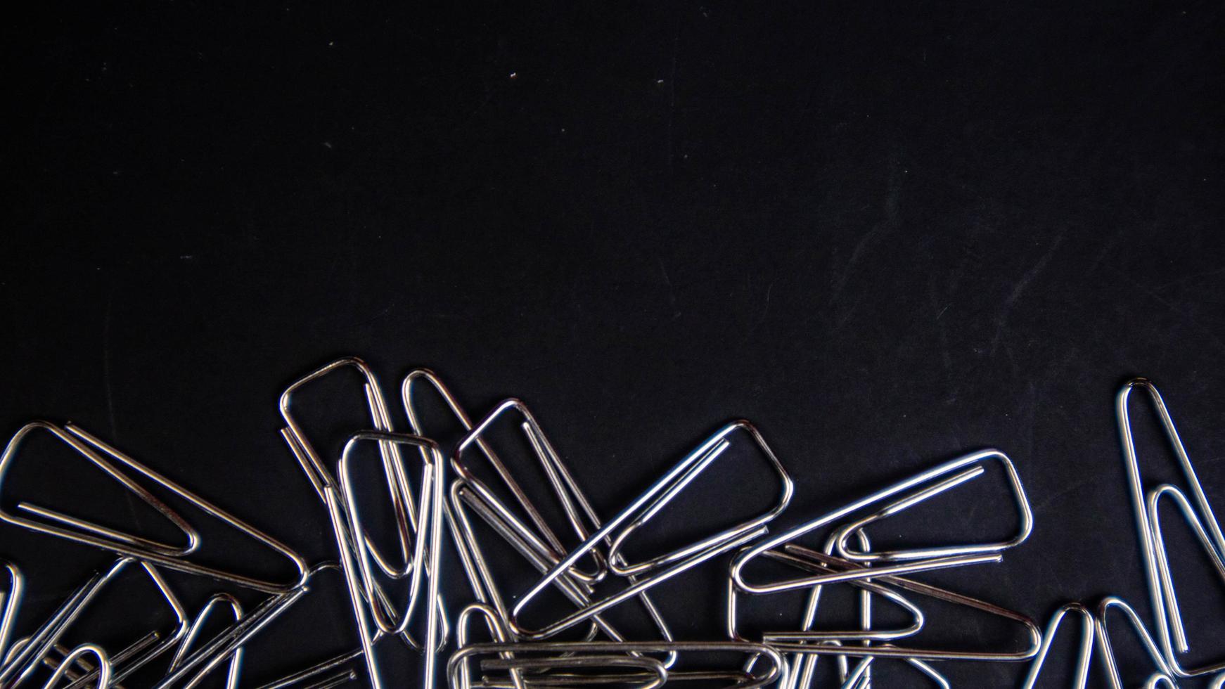 a paper clip on a black background photo