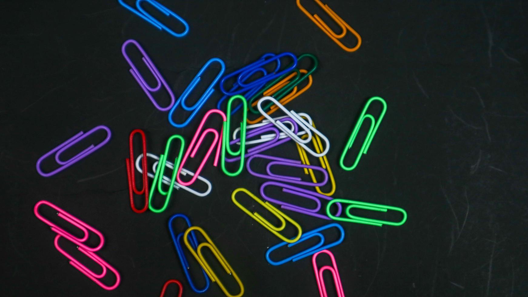 Paper clip isolated on a black background photo