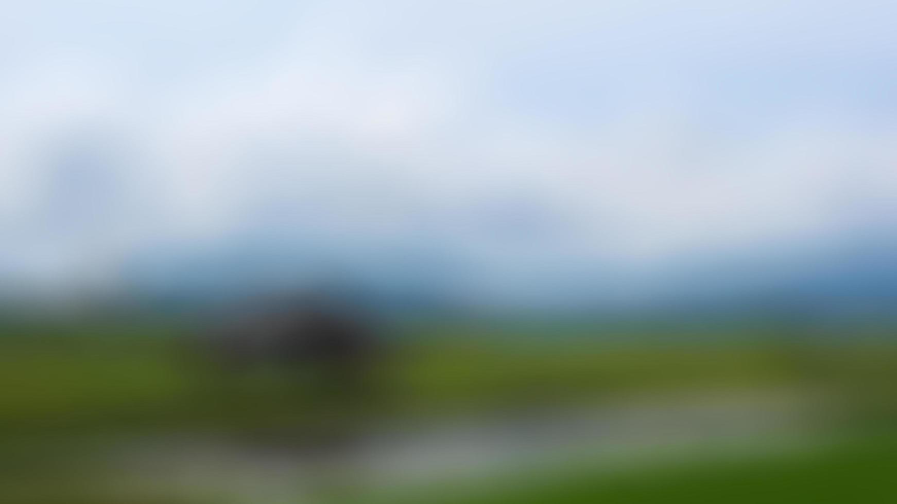 defocused cabin in the middle of the rice fields surrounded by hills photo