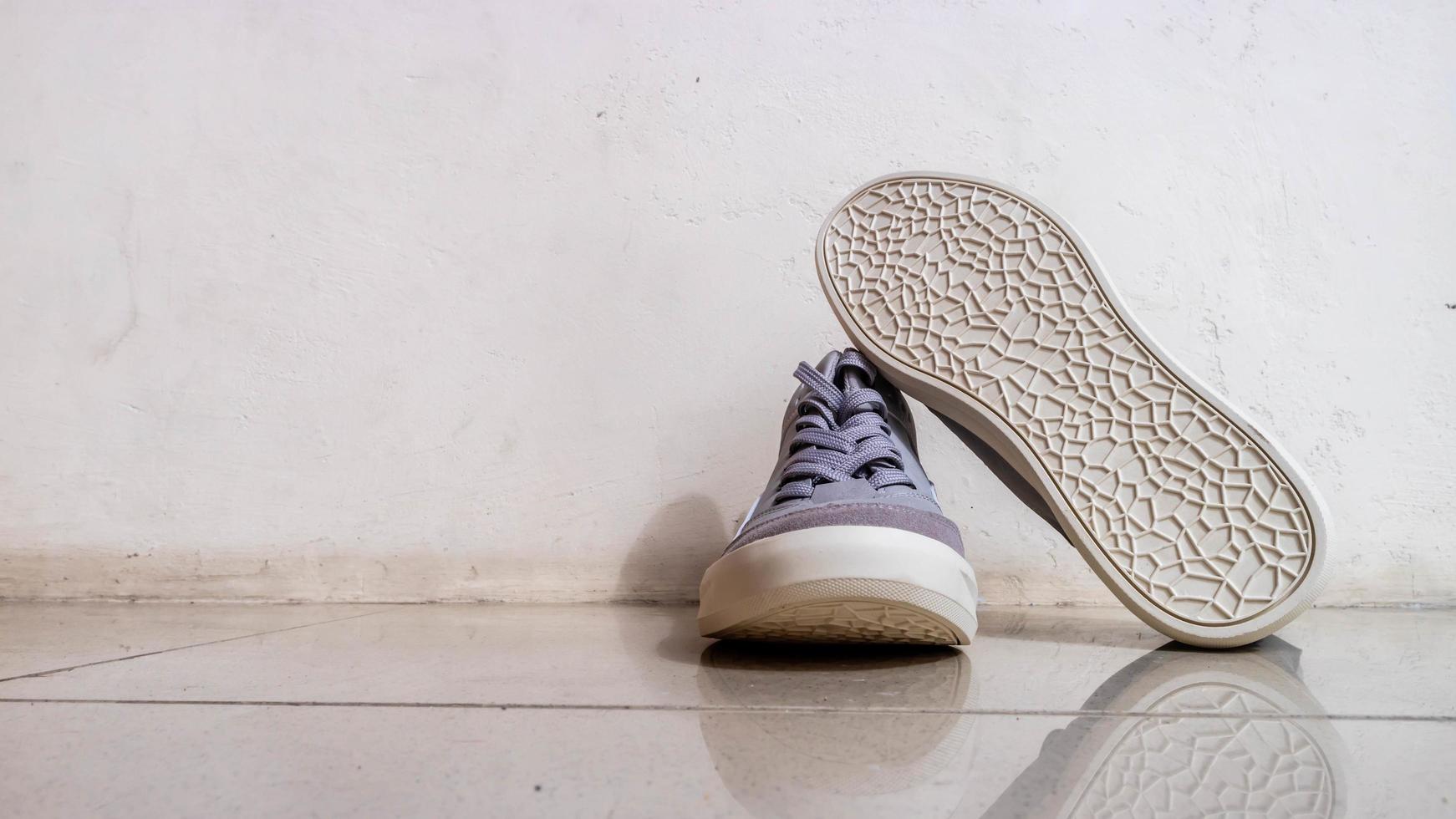 the gray sneakers on the floor photo