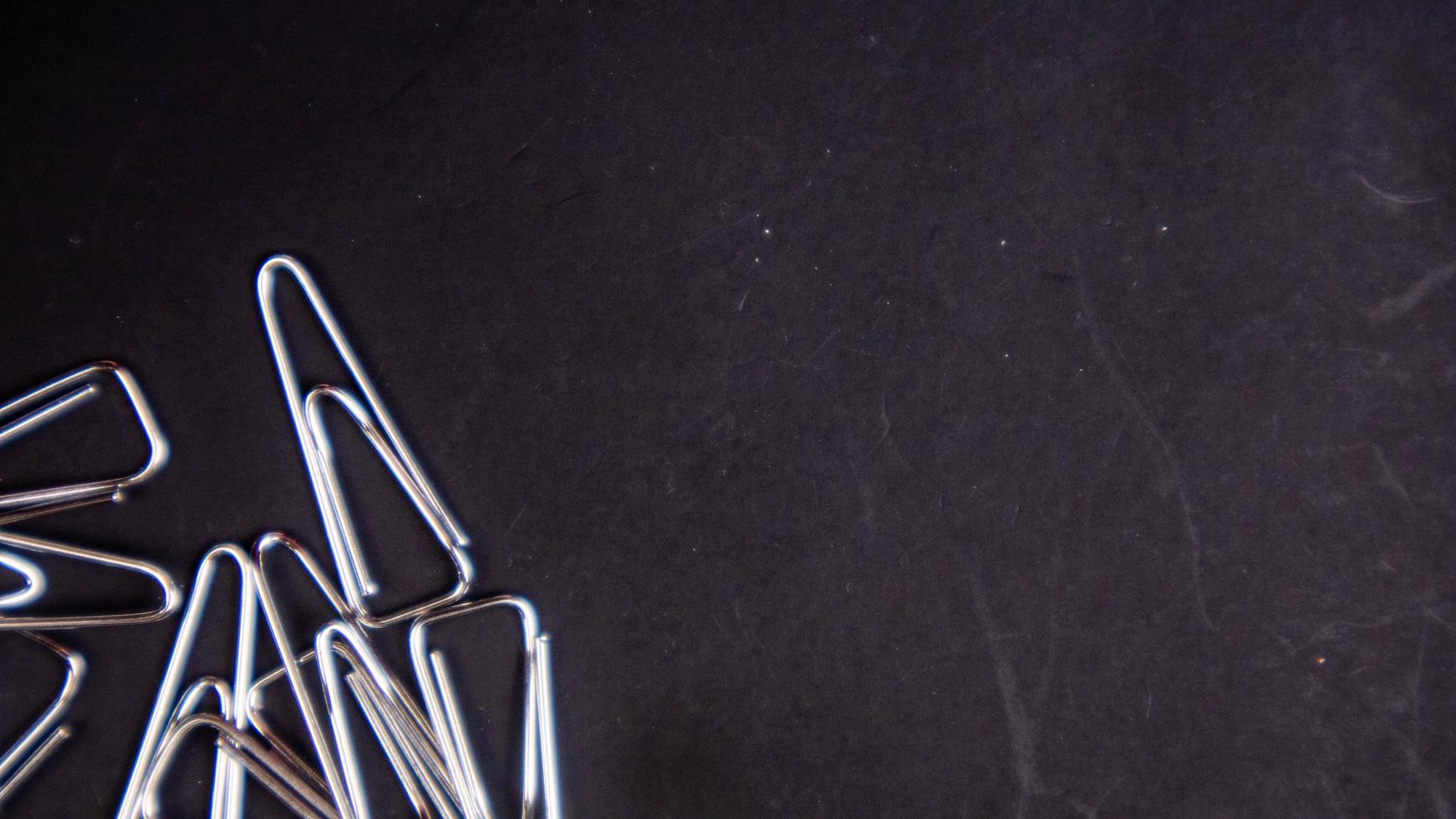 a paper clip on a black background photo