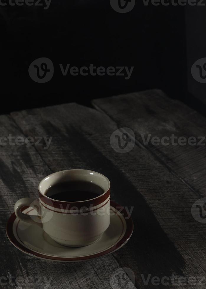 cup of hot tea on a wooden table photo