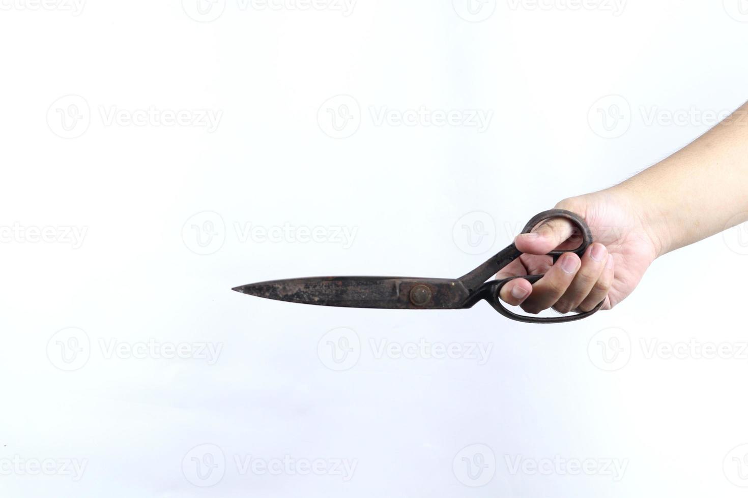 hand holding scissors isolated on white background photo