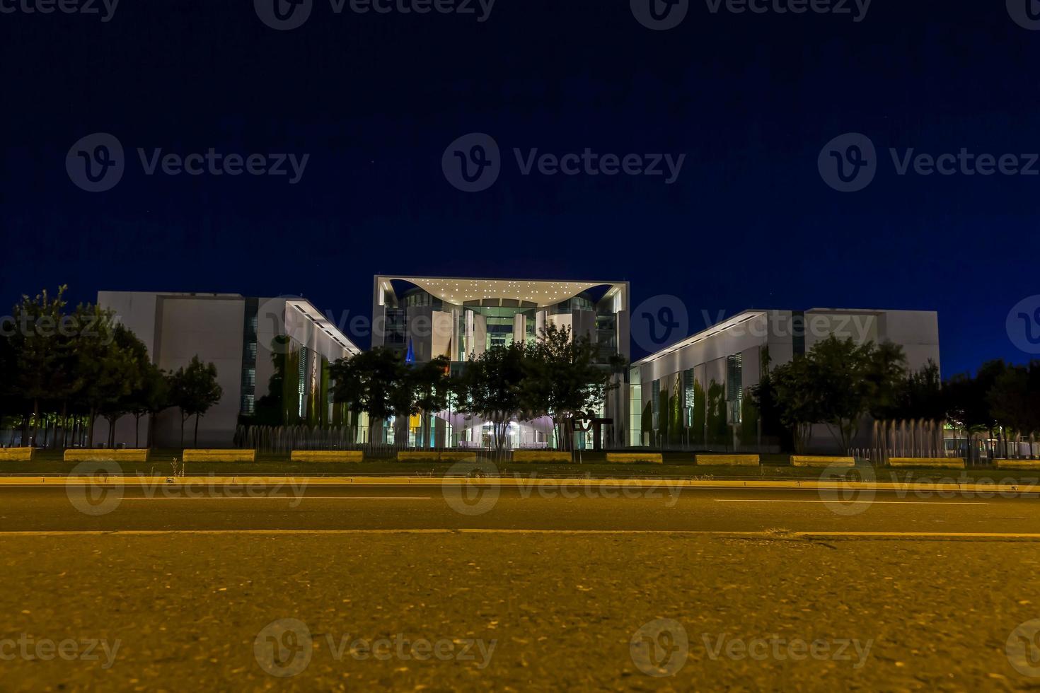 View on illuminated chancellery in Berlin at night from ground perspective photo