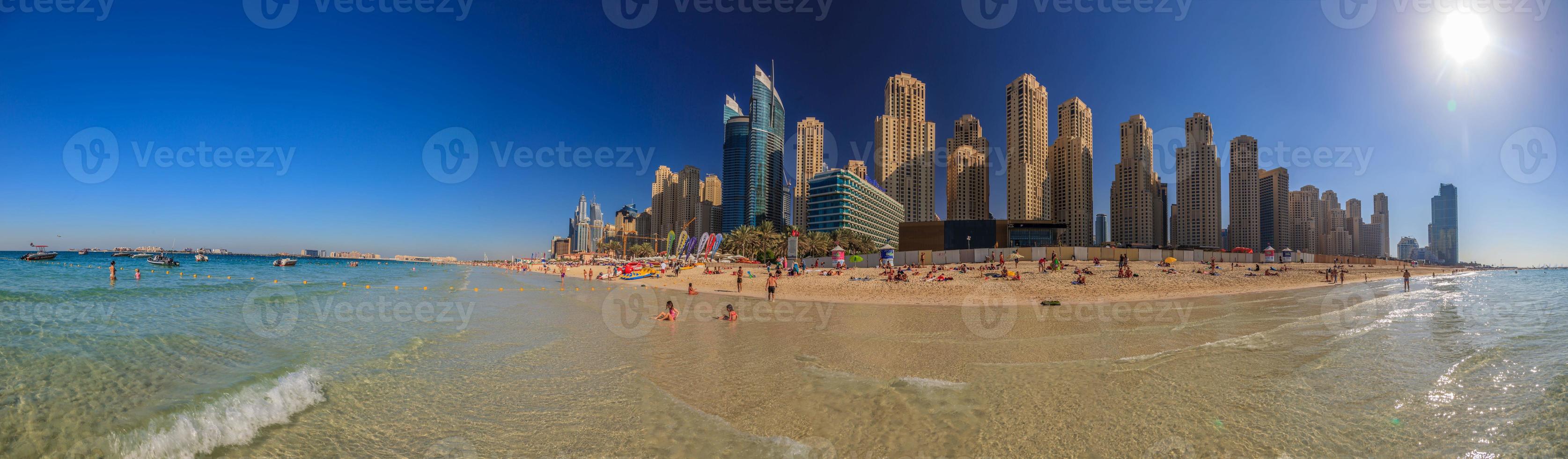 Picture of a beach in Dubai with skyline in the background photo