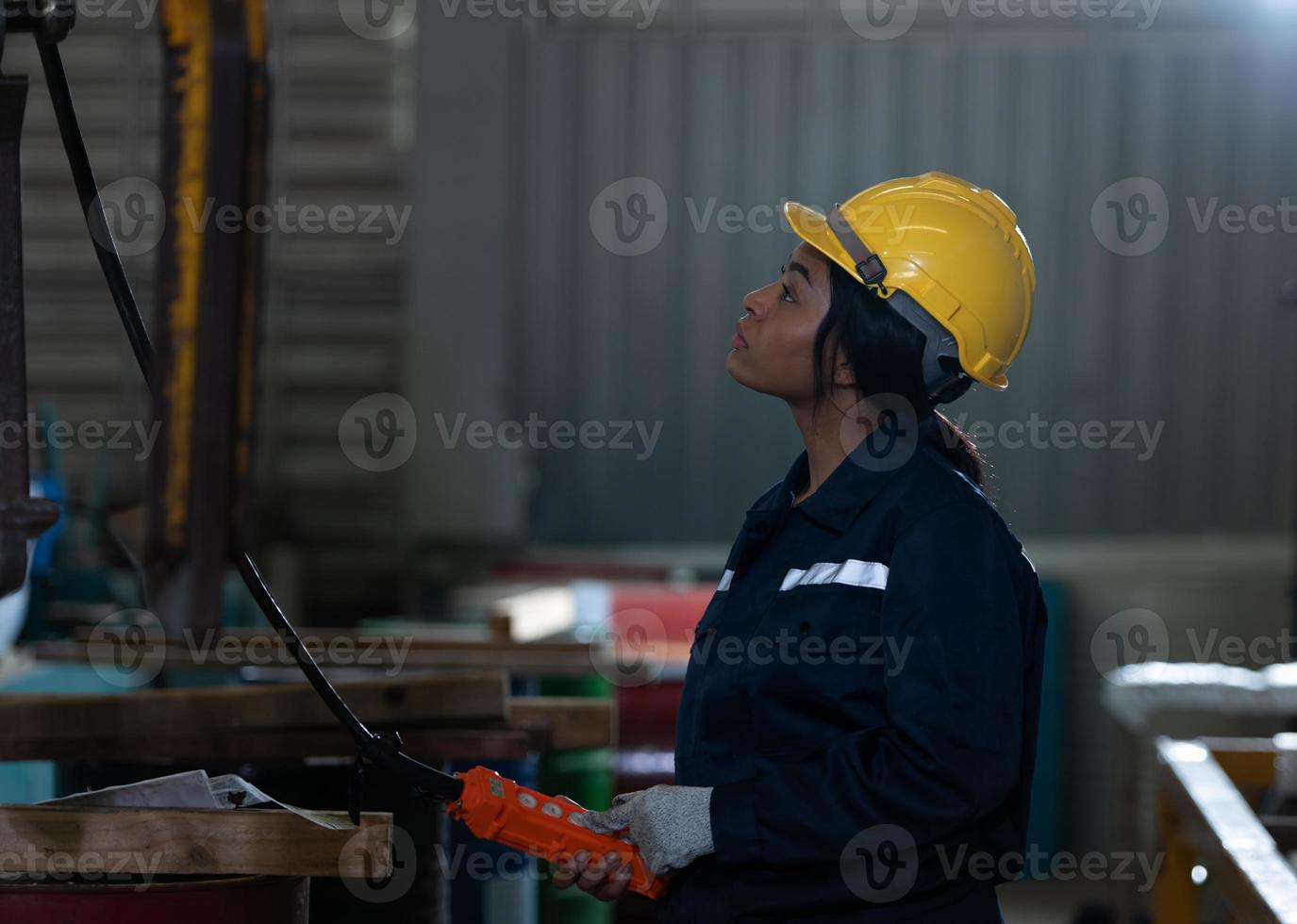 Female technicians Inspecting and testing the operation of lifting cranes photo