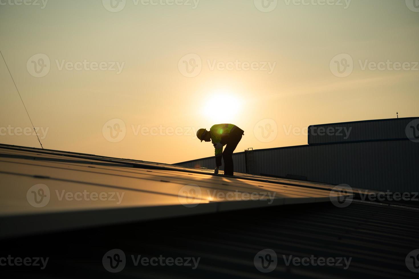 Technicians provide quarterly solar cell maintenance services on the factory roof photo