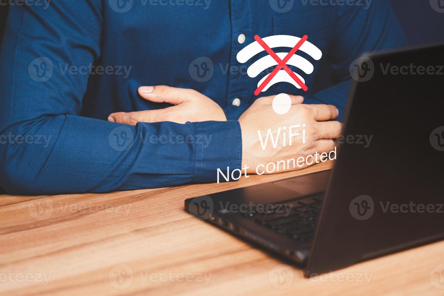 Man using a computer laptop to connect to wifi but wifi not connected, and waiting to loading digital business data form website, concept technology of waiting for connect to wifi. photo