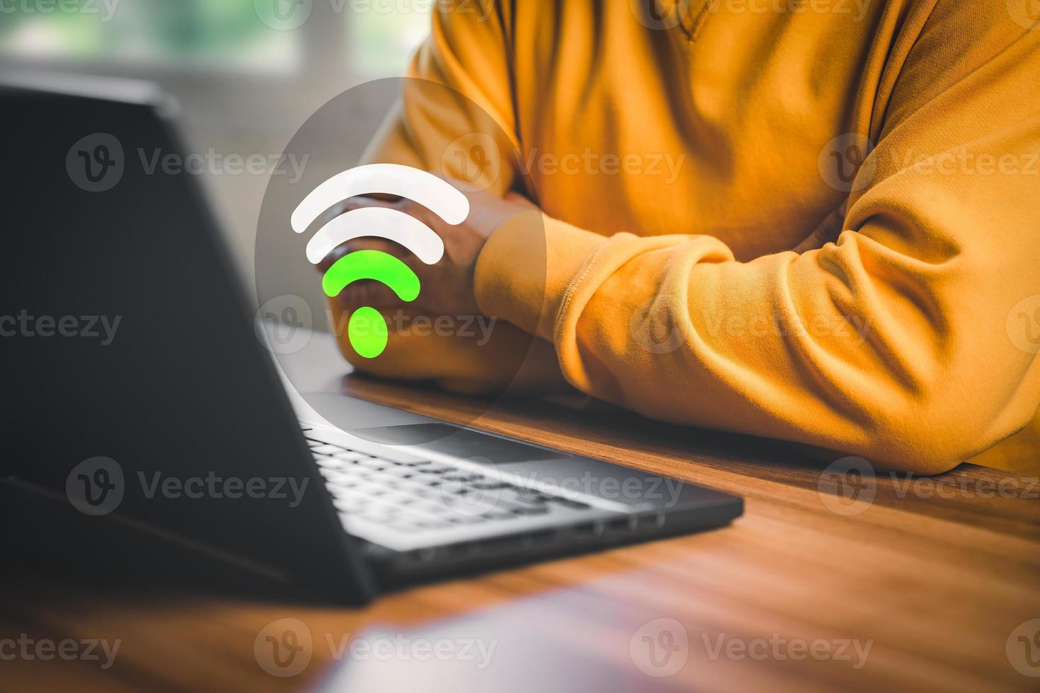 Man using a computer laptop to connect to wifi but wifi signal is very weak, and waiting to loading digital business data form website, concept of waiting for connect to wifi. photo