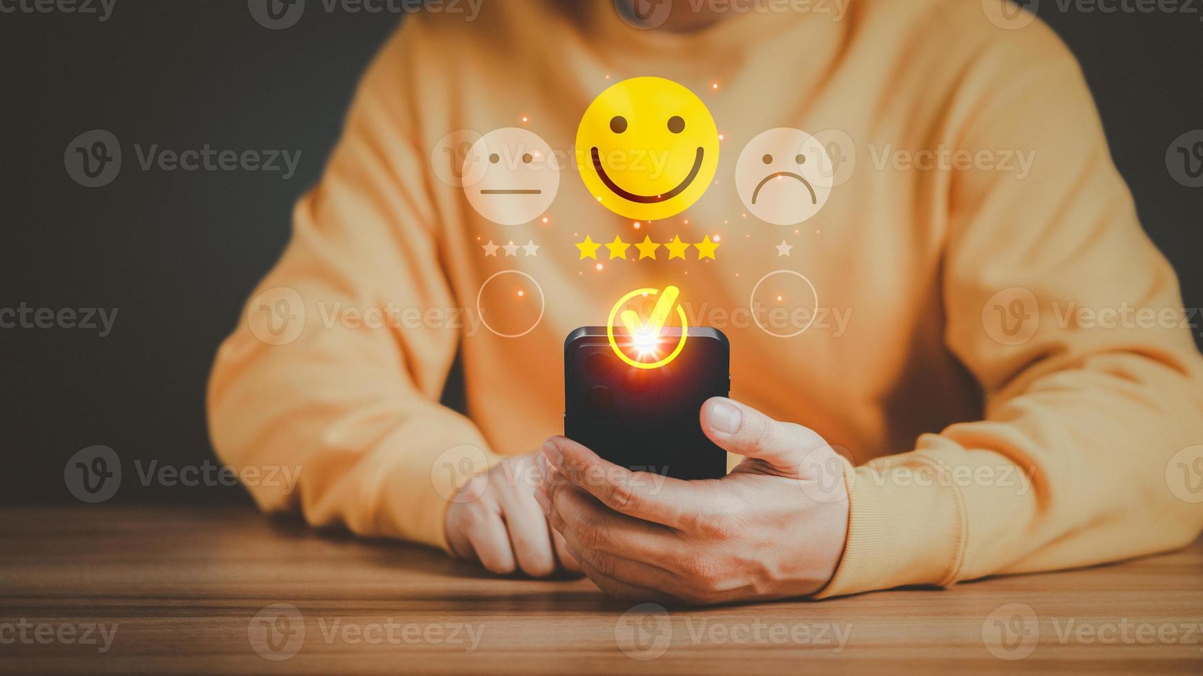 Man using a mobile phone in give rating to service experience on application. Online customer review satisfaction feedback survey and testimonial. photo