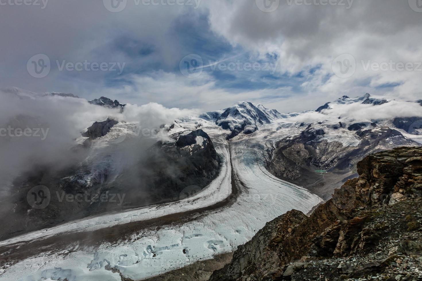 Panorama of stunning mountains and glaciers above, Switzerland. photo