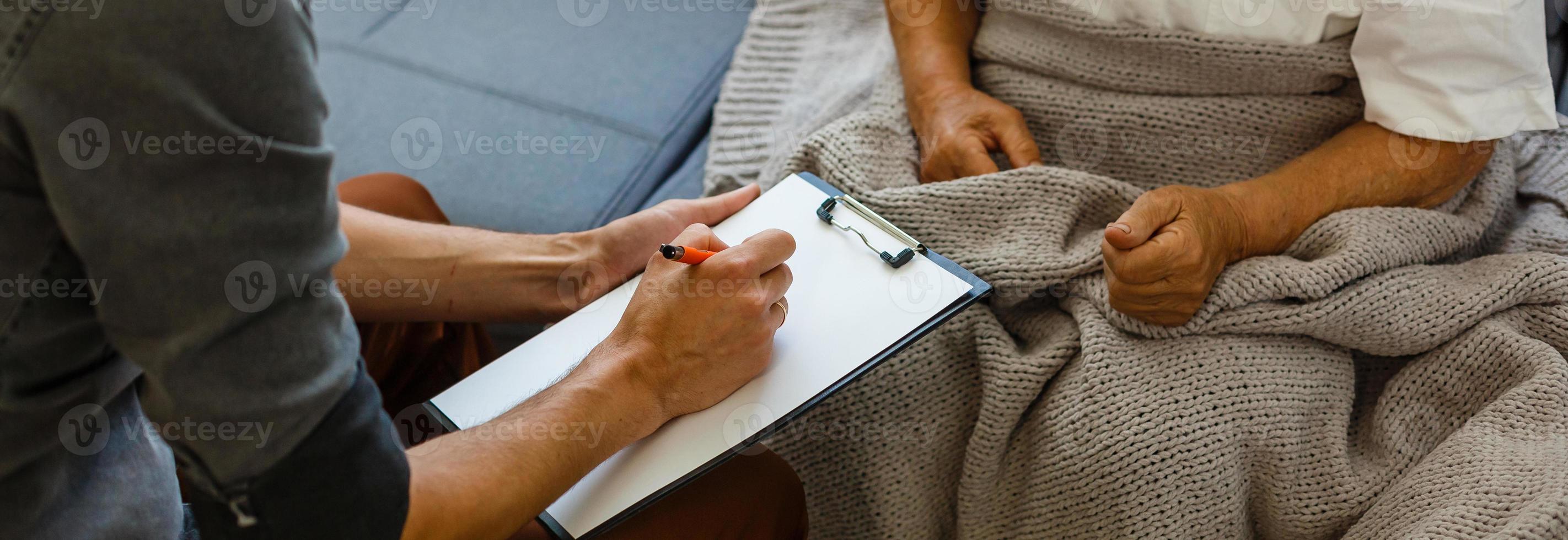 Senior woman with her home caregiver photo