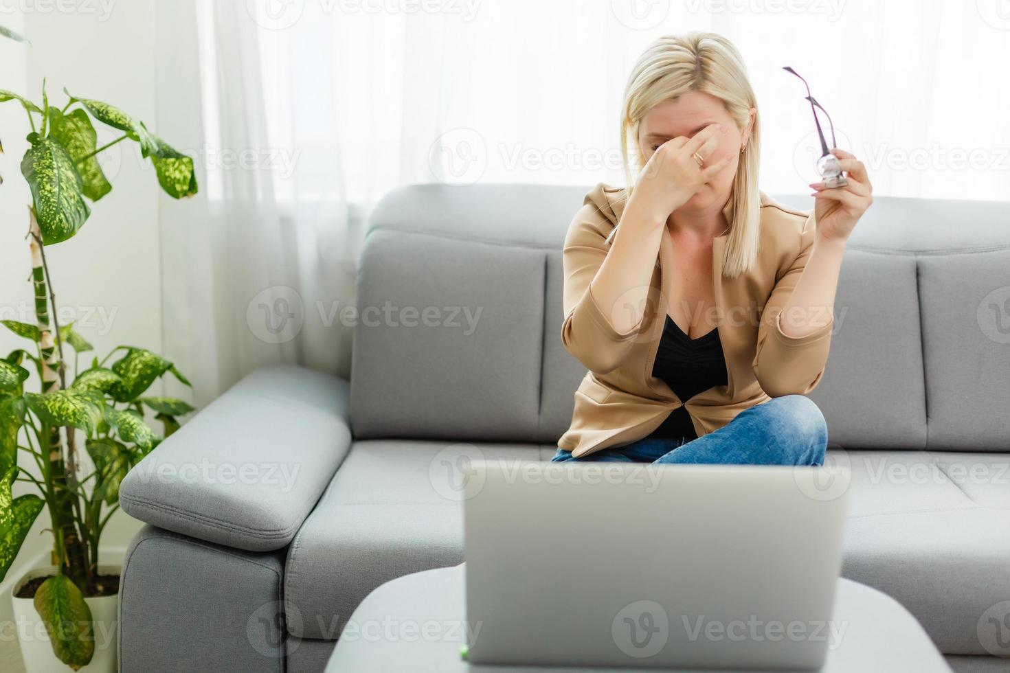 Work during quarantine, a woman at home works on the laptop photo