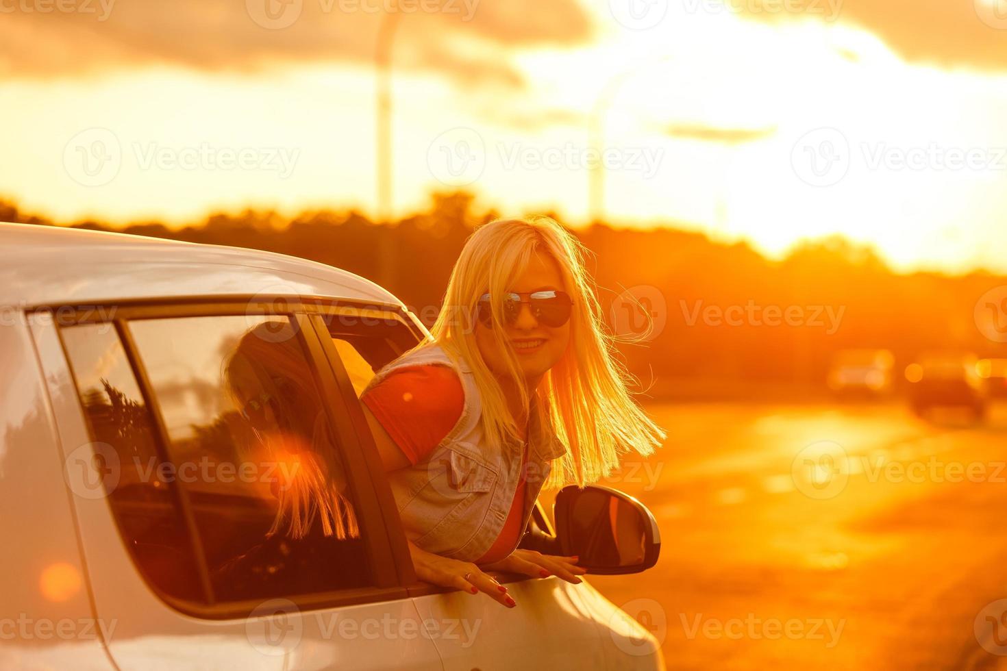 happy woman girl goes to summer travel trip in car. photo