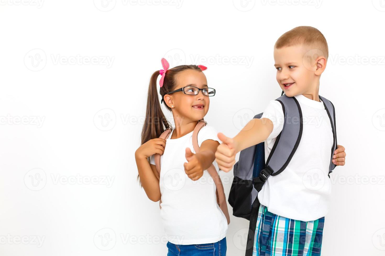 Children's fashion. Modern boy and girl posing together at studio. Education. photo