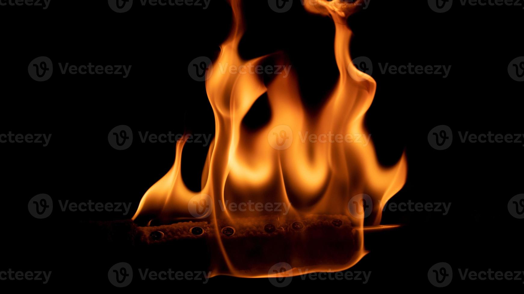 A beautiful shot of a person doing a fire Poi show in the dark photo