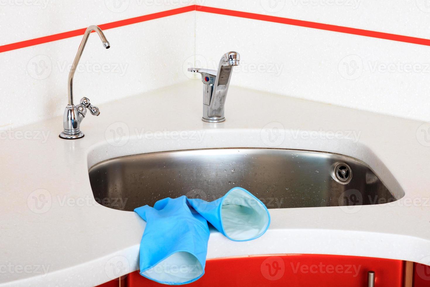 Closeup shot of stainless steel kitchen sink photo