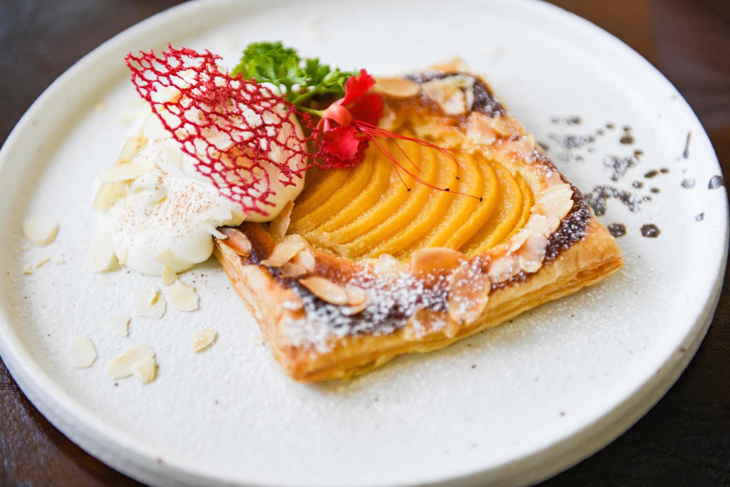 Peach Pie on white plate - Homemade dessert delicious cake with peaches and icing sugar photo