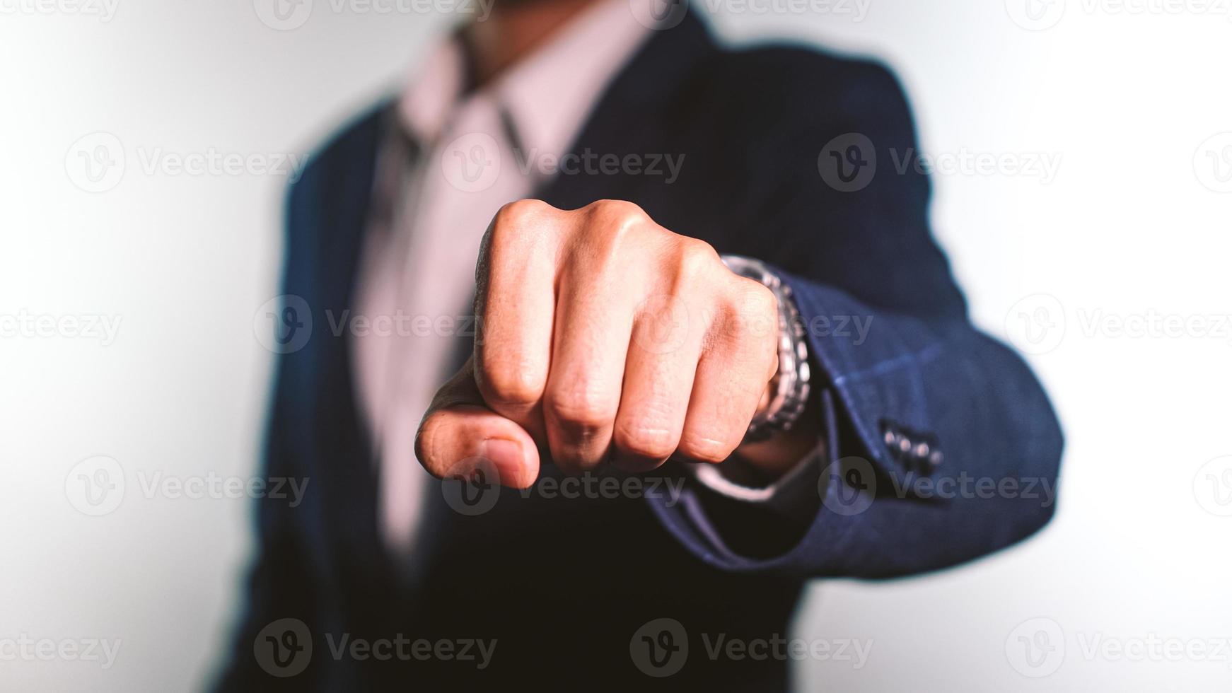 Close up of young businessman fist bump on white background. Business people wear suit do a fist pump together after good deal. Business success and teamwork concept. photo