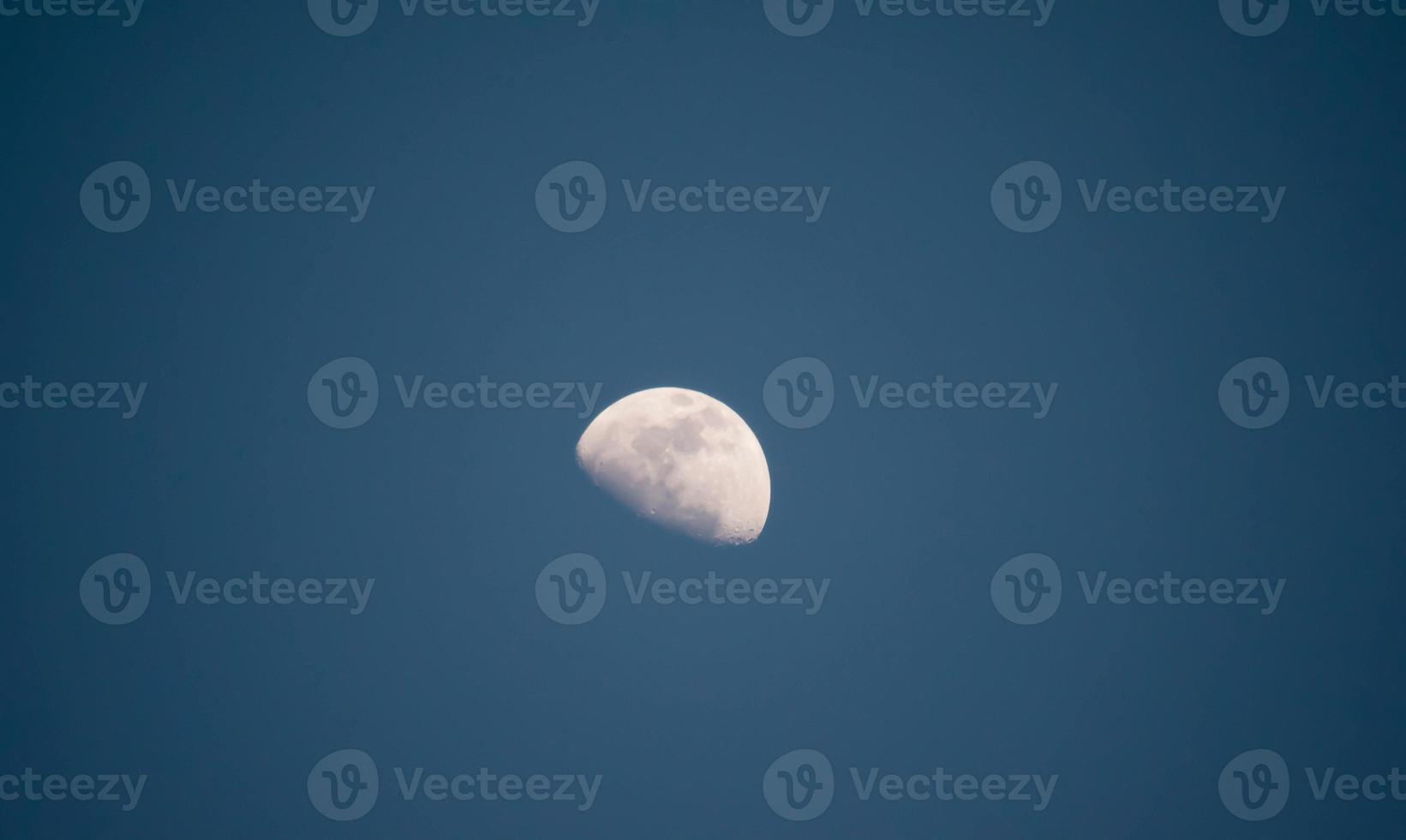 moon view with blue sky in evening time photo