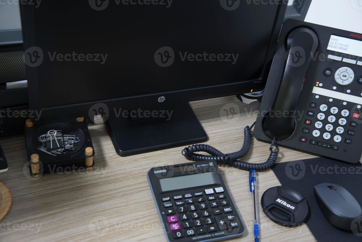 office desk stuff with phone mouse and keyboard photo