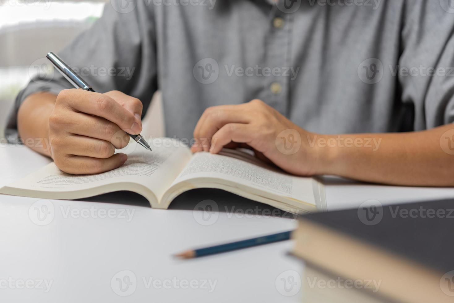 Businessperson reading and writing on book.education studying knowledge development and cognition learning concept. photo