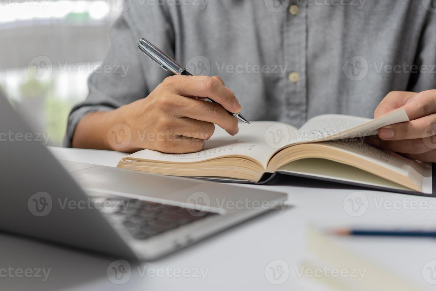 learning online class by using laptop computer and writing notebook at workplace, Education development or knowledge improvement concept. photo