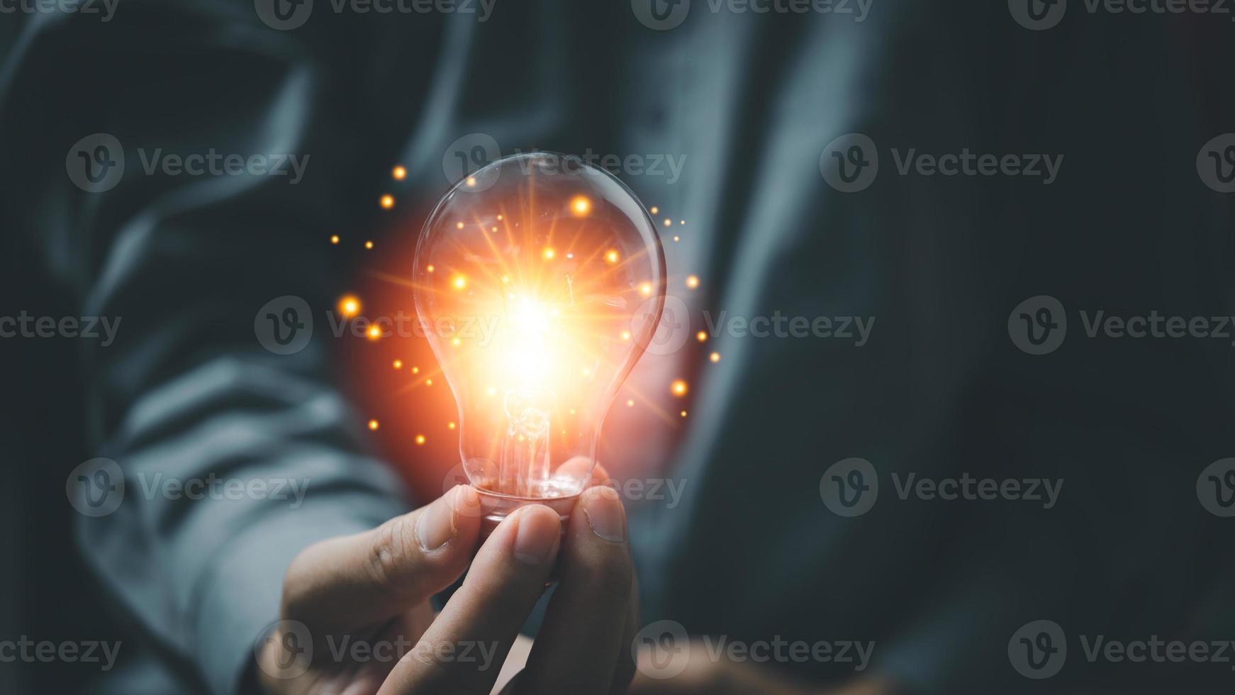 Man holding glowing light bulbs. Inspiration ideas of studying in education with innovative technology and creativity. Success concept of knowledge or cognition inspiration and motivation concept photo