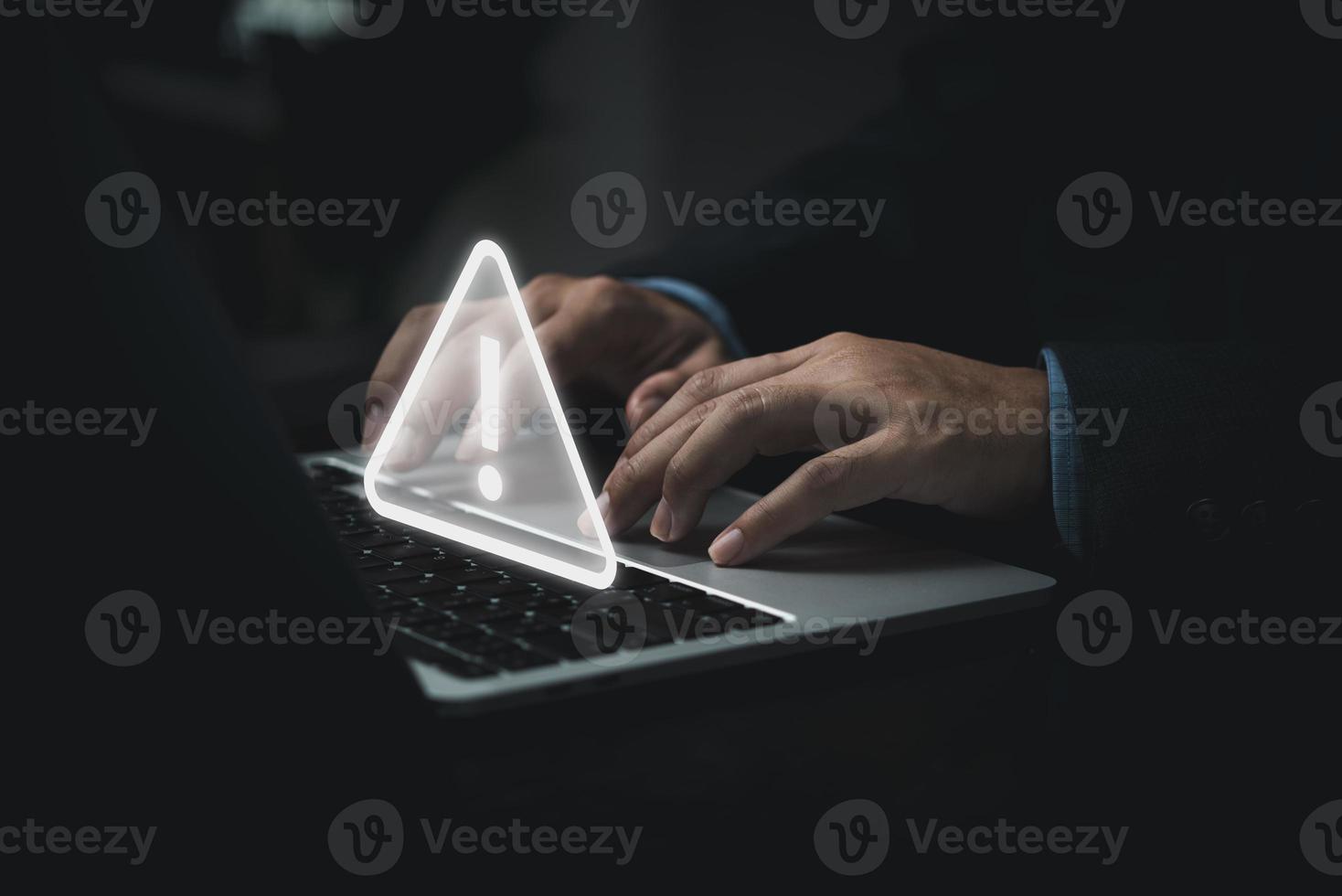 Businessman programmer, developer using laptop computer with triangle caution warning sign for notification error and maintenance concept. photo