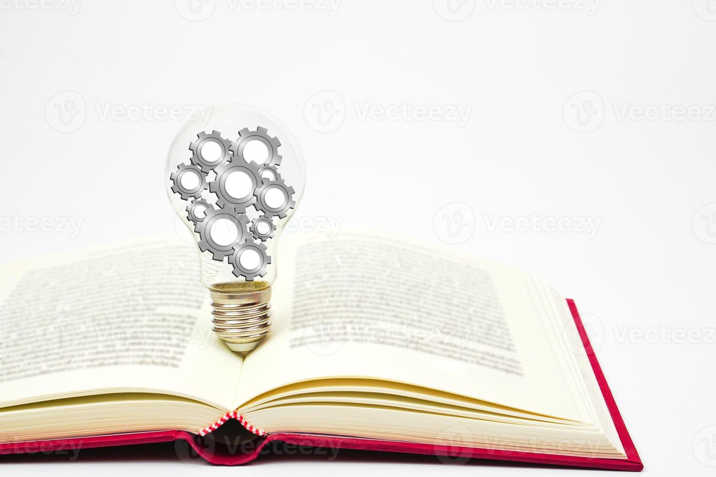 Light bulb with gear or cogwheel is placed on book. Concept of knowledge, wisdom, new ideas and creativity. photo