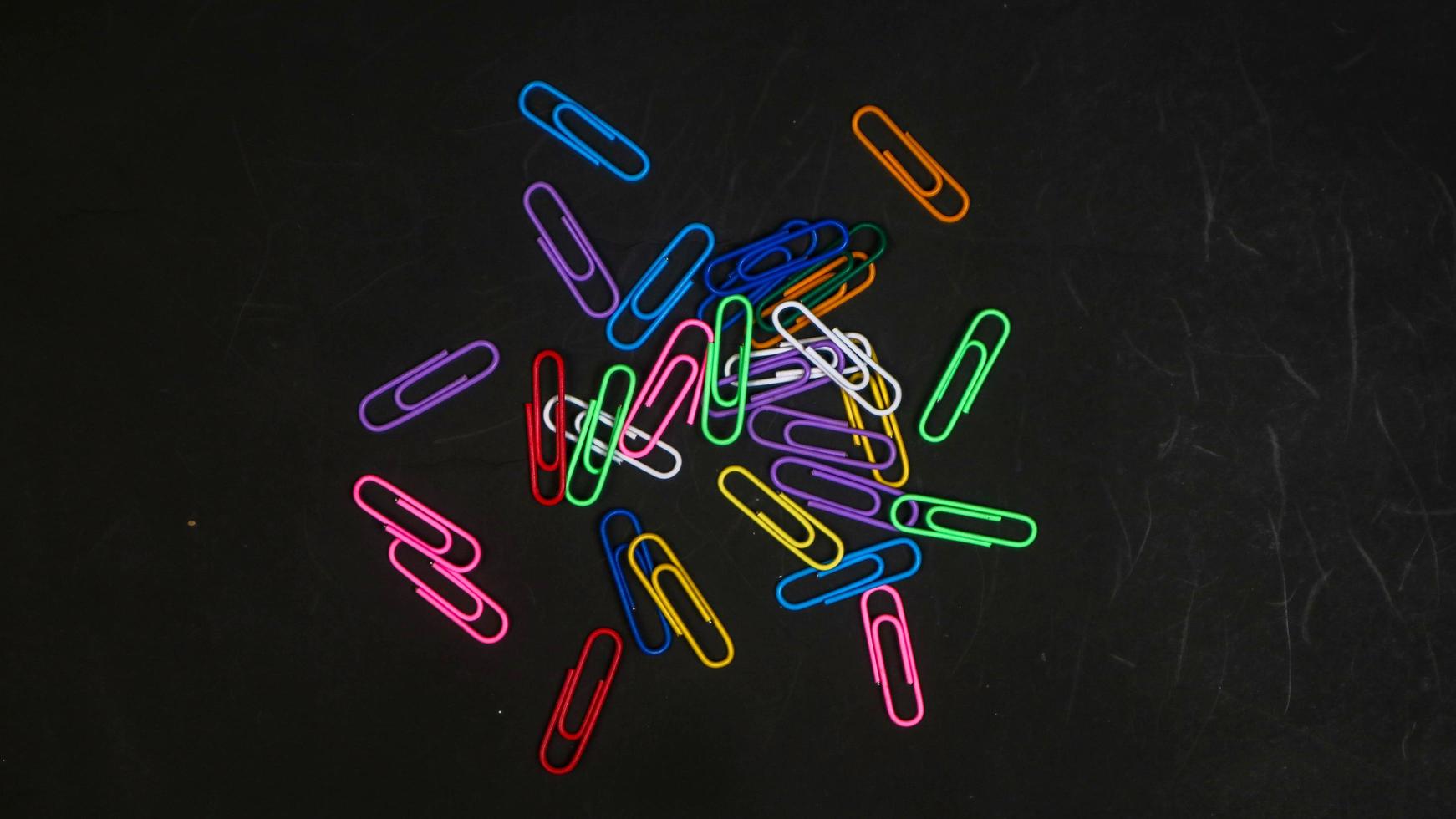 Paper clip isolated on a black background photo