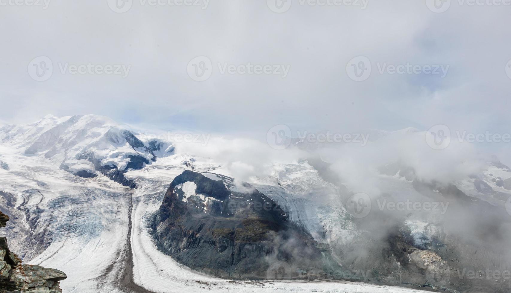 Panorama of stunning mountains and glaciers above, Switzerland. photo