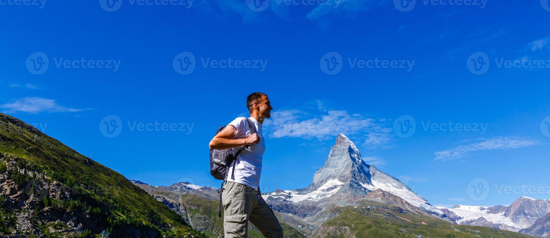 Traveler Man relaxing meditation with serene view mountains landscape Travel Lifestyle hiking concept summer vacations outdoor photo