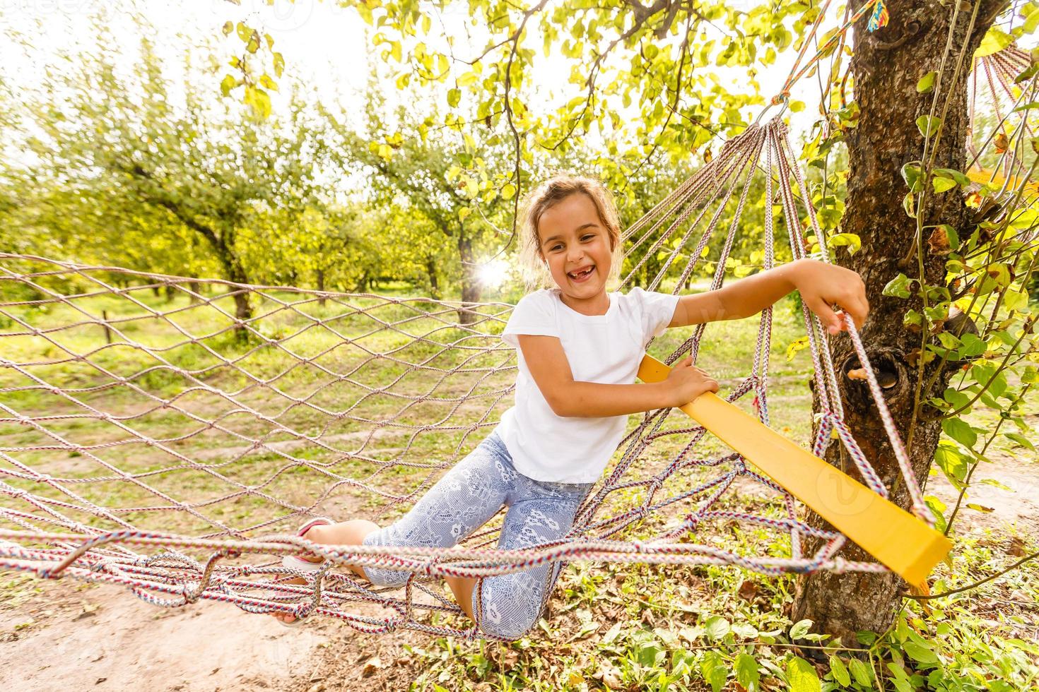 Summer vacation - Hammock Relaxing Child rest. Little girl lying lazily in hammock photo