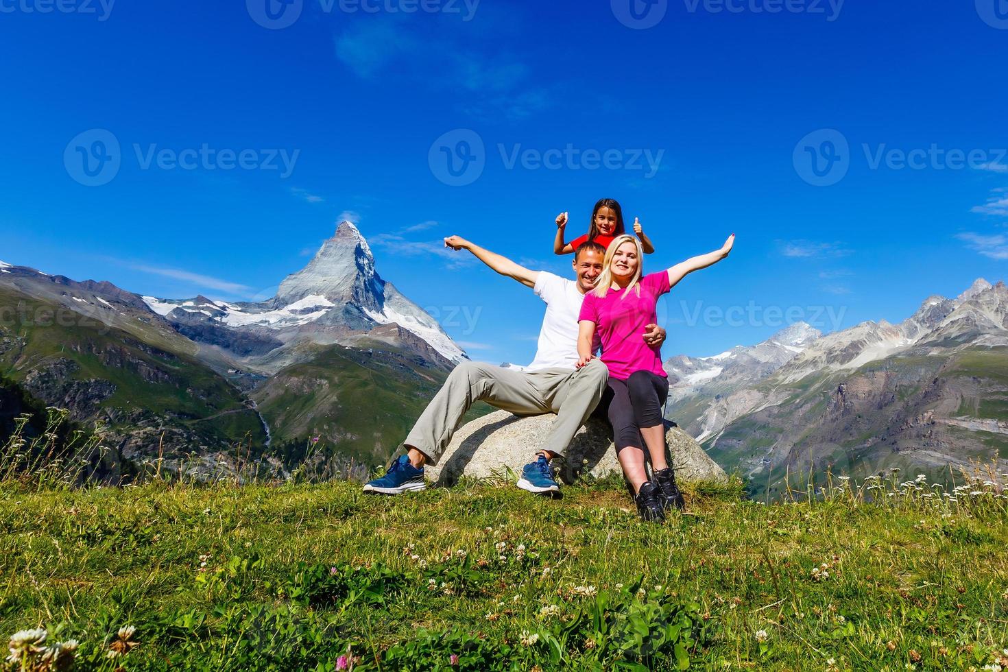 Family on a trek day in the mountain looking at the view photo