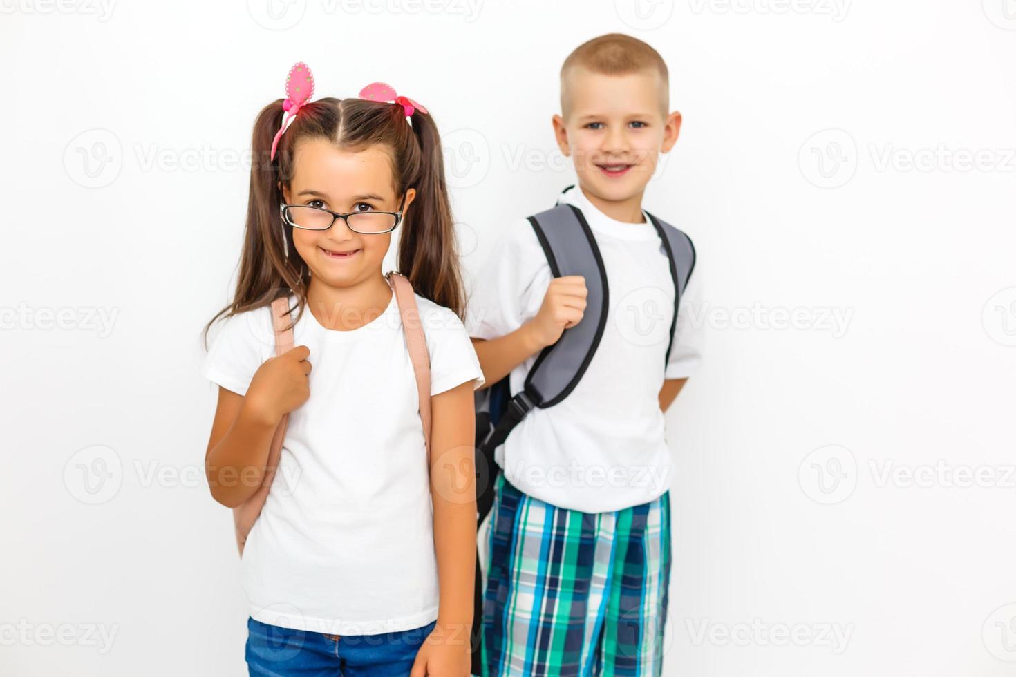 Children's fashion. Modern boy and girl posing together at studio. Education. photo