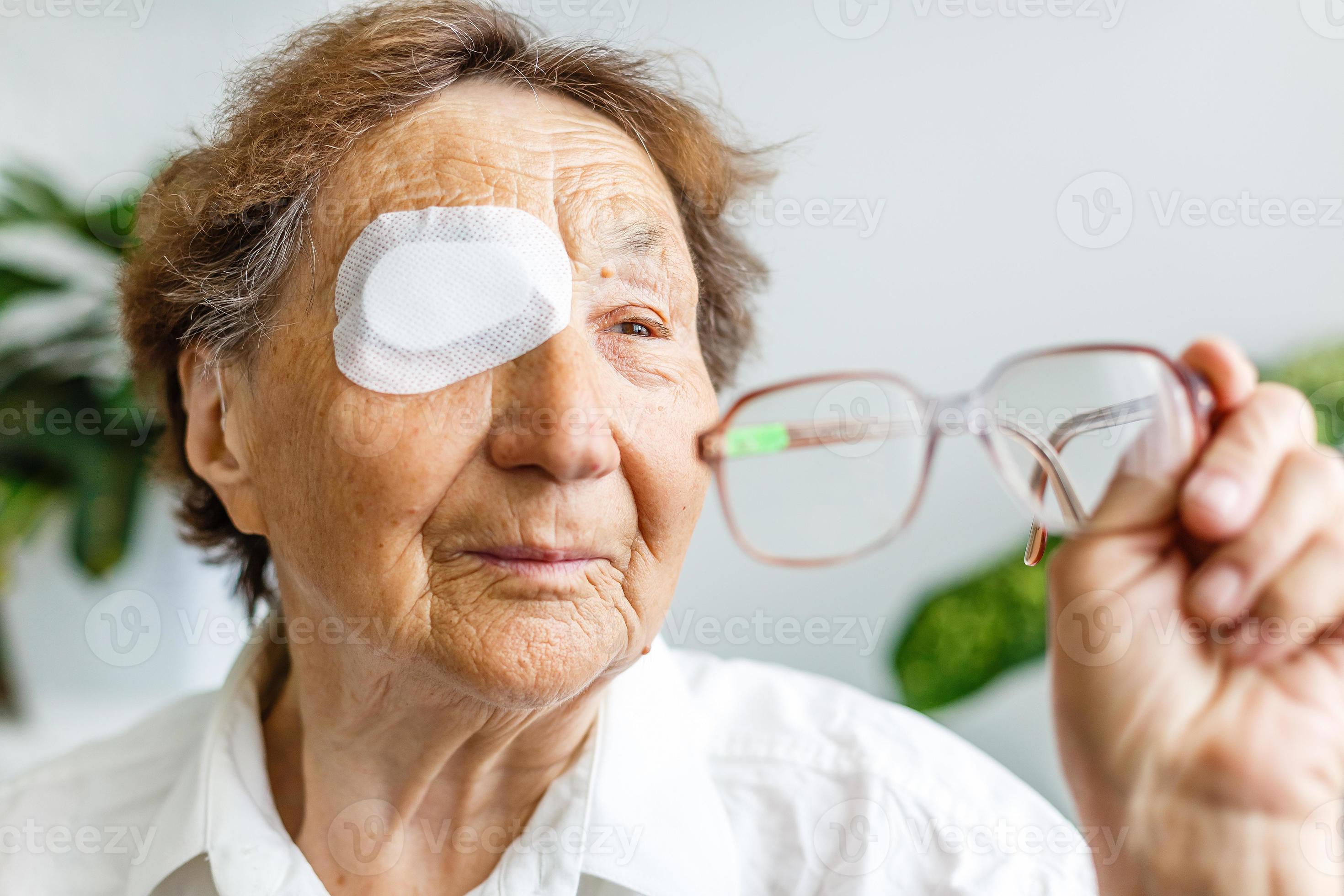 Elderly use eye shield covering after cataract surgery. 16780470 Stock