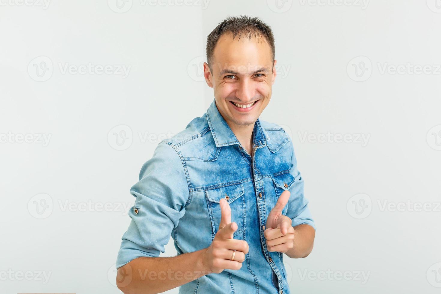 Image of positive guy 30s laughing and pointing fingers at camera like hey you isolated over white background photo