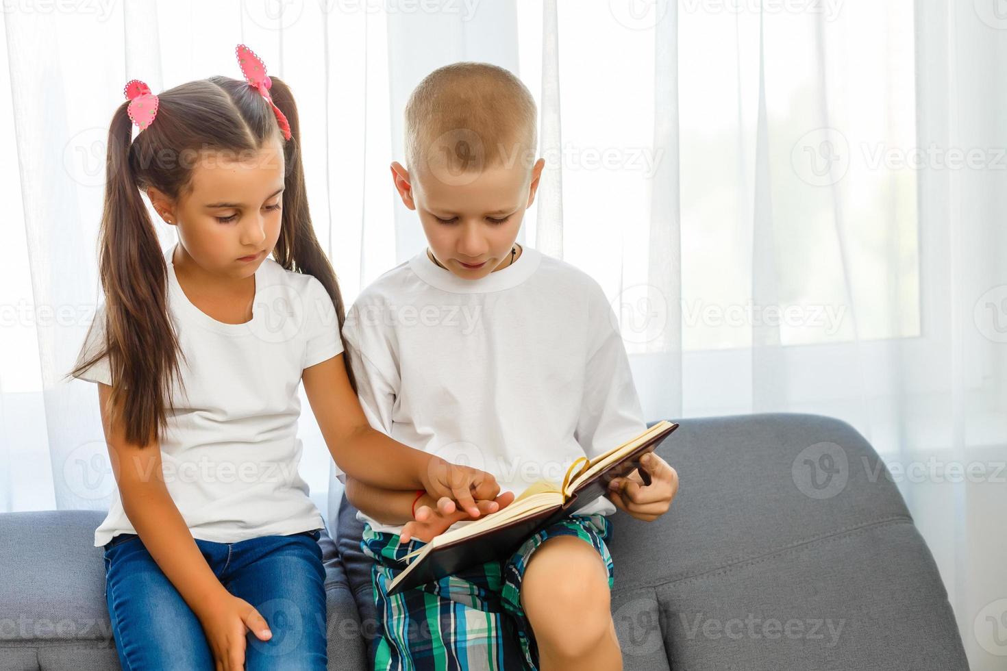 children read a book at home photo