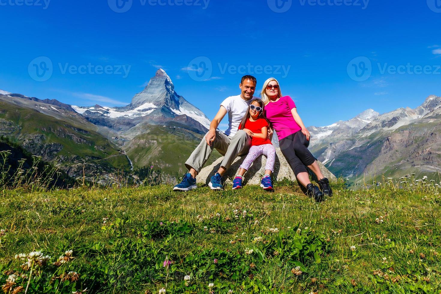 Family on a trek day in the mountain looking at the view photo