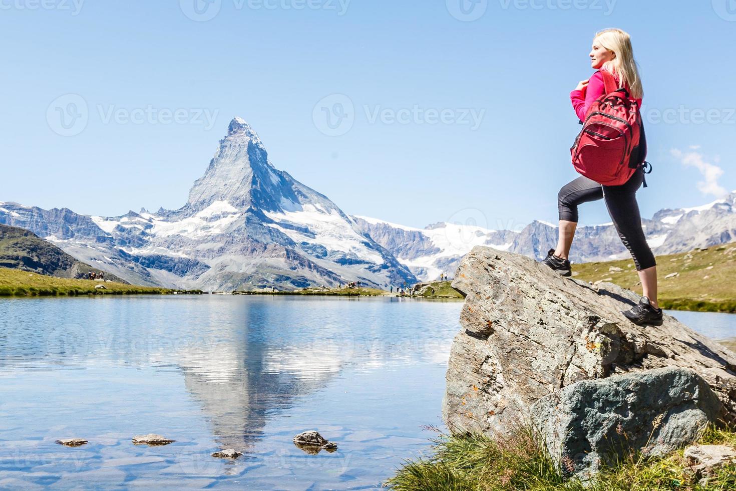 woman looking at the beautiful Mount Matterhorn in the Swiss Alps photo