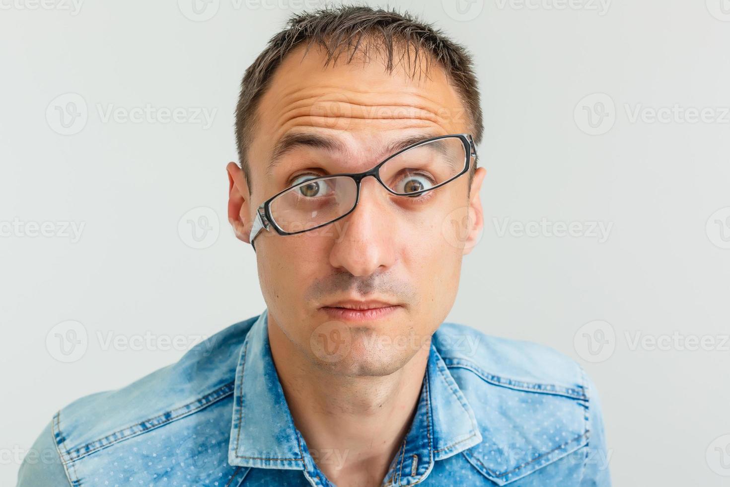 retrato de primer plano de un joven nerd enojado, enojado y frustrado con grandes anteojos, gritando puños levantados, aislado en fondo blanco. emociones negativas expresiones faciales sentimientos, lenguaje corporal foto