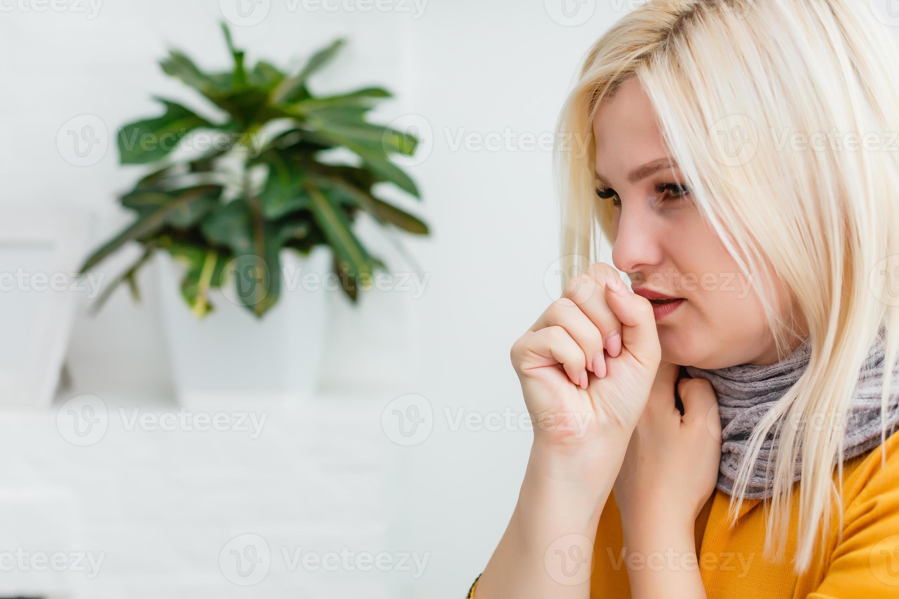 Closeup portrait of unhealthy young European blonde woman coughing a lot, suffering with cough