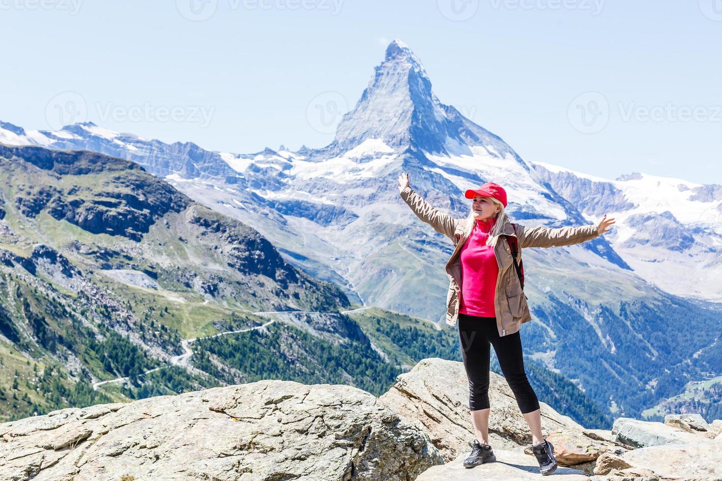 woman looking at the beautiful Mount Matterhorn in the Swiss Alps photo